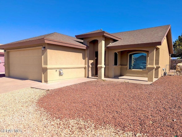 14161 Honey Point Dr, El Paso, TX 79938 - ranch-style house featuring stucco siding, an attached garage, and driveway