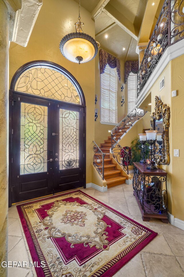 605 Meadow Willow Dr, El Paso, TX 79922 - foyer featuring a high ceiling, stairs, beam ceiling, stone tile flooring, and french doors