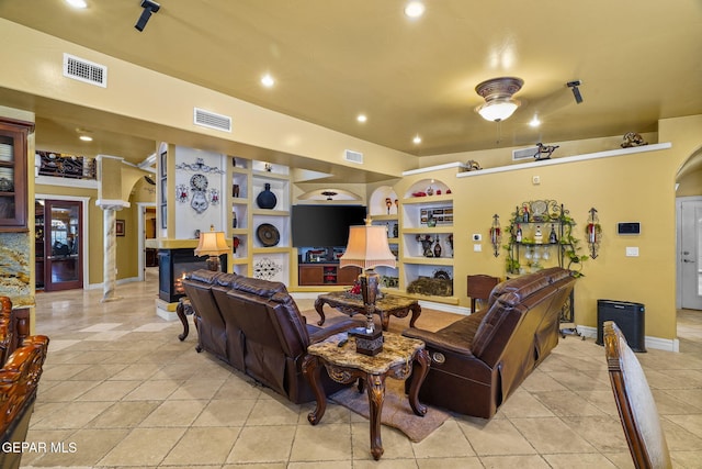 605 Meadow Willow Dr, El Paso, TX 79922 - living area with built in features, recessed lighting, light tile patterned floors, arched walkways, and decorative columns