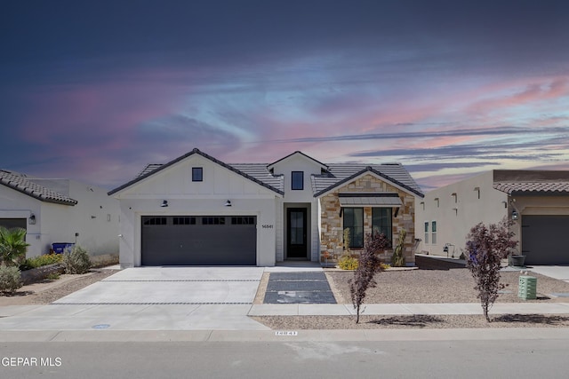 14841 Mike A Mendoza Ave, El Paso, TX 79938 - modern inspired farmhouse featuring concrete driveway, a garage, stone siding, and board and batten siding