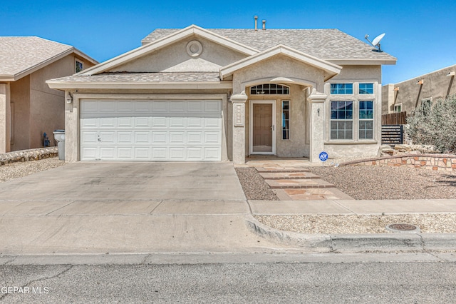 10937 Acoma St, El Paso, TX 79934 - view of front facade with driveway, stucco siding, an attached garage, and a shingled roof