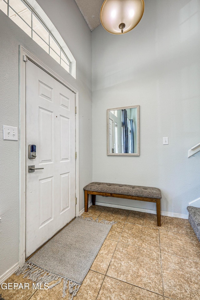 10937 Acoma St, El Paso, TX 79934 - tiled foyer entrance featuring a high ceiling and stairs