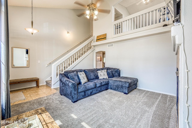 10937 Acoma St, El Paso, TX 79934 - carpeted living area with ceiling fan, a high ceiling, stairway, and arched walkways