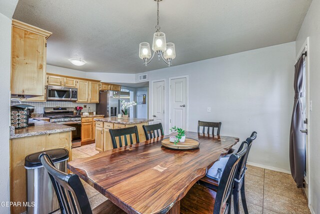10937 Acoma St, El Paso, TX 79934 - dining room with a chandelier, light tile patterned floors, and a textured ceiling