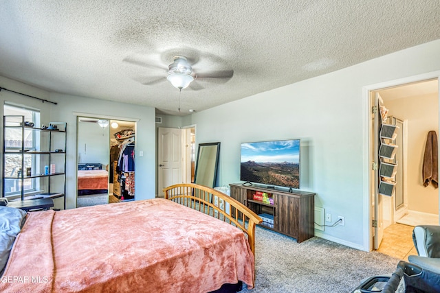 10937 Acoma St, El Paso, TX 79934 - bedroom with carpet flooring, a textured ceiling, ensuite bath, a walk in closet, and ceiling fan