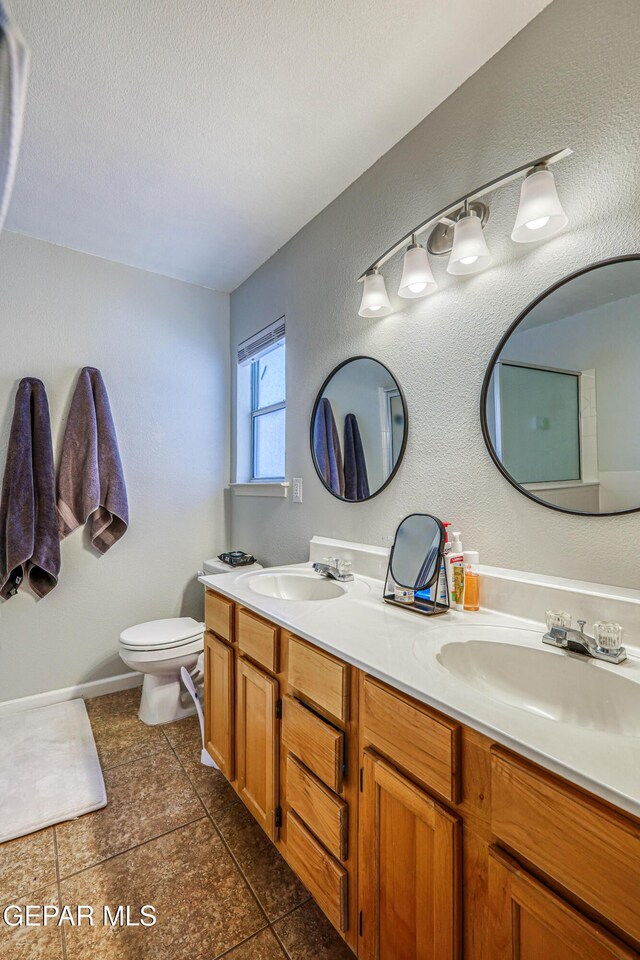 10937 Acoma St, El Paso, TX 79934 - full bath featuring double vanity, a textured ceiling, tile patterned floors, and a textured wall