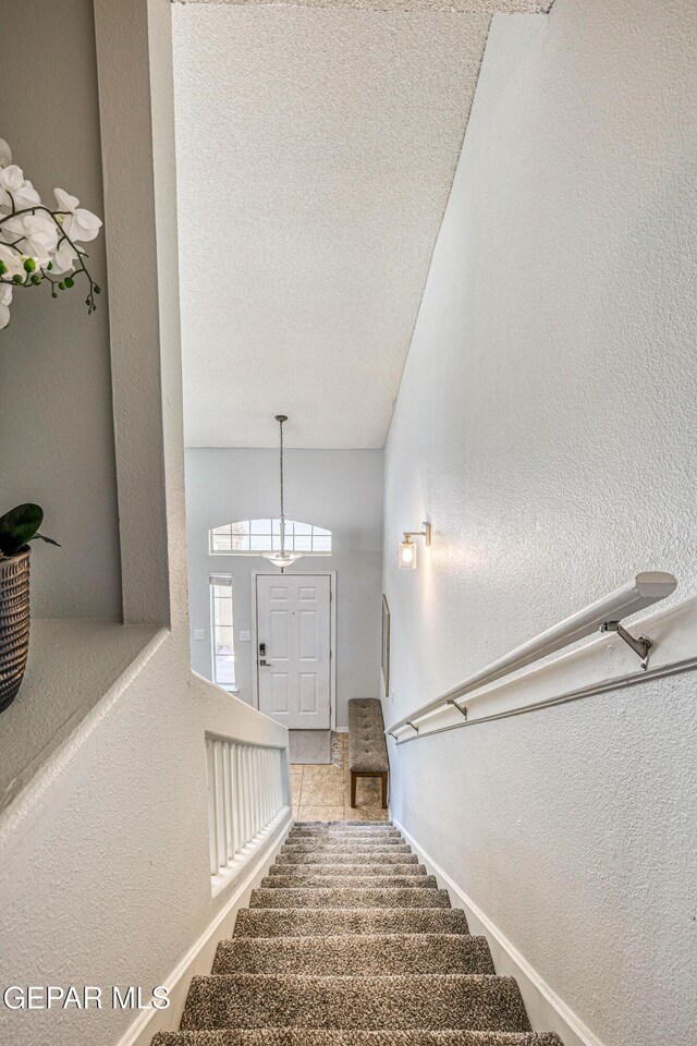 10937 Acoma St, El Paso, TX 79934 - stairway featuring a textured wall and a textured ceiling