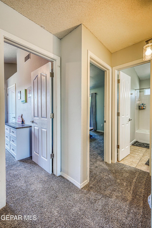 10937 Acoma St, El Paso, TX 79934 - hallway with carpet floors and a textured ceiling