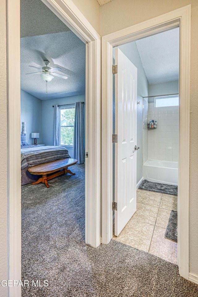 10937 Acoma St, El Paso, TX 79934 - bathroom with a textured ceiling, ceiling fan, bathtub / shower combination, and tile patterned floors