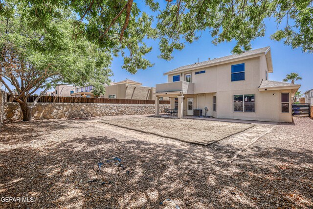 10937 Acoma St, El Paso, TX 79934 - back of property featuring a fenced backyard, a patio area, stucco siding, and a shingled roof