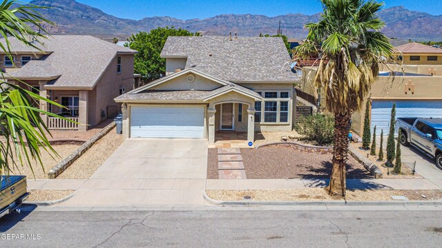 10937 Acoma St, El Paso, TX 79934 - view of front of house featuring concrete driveway, a mountain view, an attached garage, and stucco siding