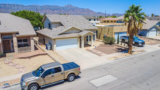 10937 Acoma St, El Paso, TX 79934 - view of front of property featuring a mountain view, stucco siding, driveway, a garage, and a residential view