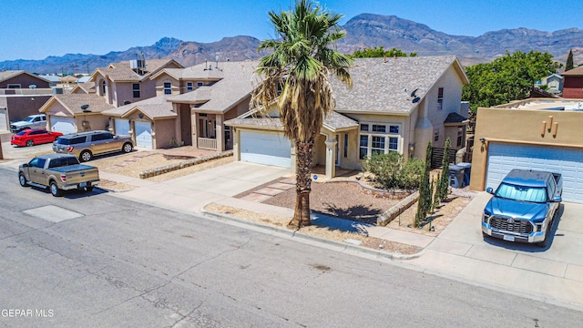 10937 Acoma St, El Paso, TX 79934 - traditional-style home with concrete driveway, a mountain view, a residential view, and an attached garage