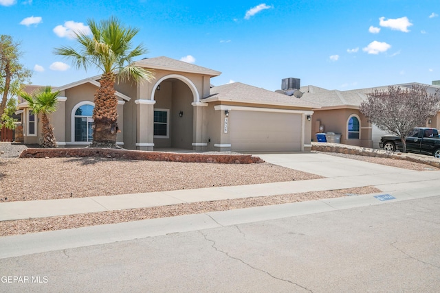 3928 Tierra Roman Dr, El Paso, TX 79938 - view of front of house with stucco siding, a garage, and driveway