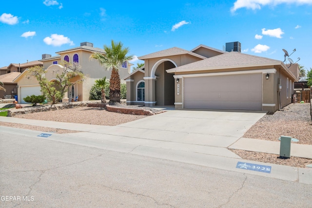 3928 Tierra Roman Dr, El Paso, TX 79938 - mediterranean / spanish home featuring a garage, stucco siding, and concrete driveway