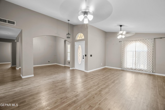 3928 Tierra Roman Dr, El Paso, TX 79938 - entrance foyer featuring a ceiling fan, arched walkways, wood finished floors, and a high ceiling