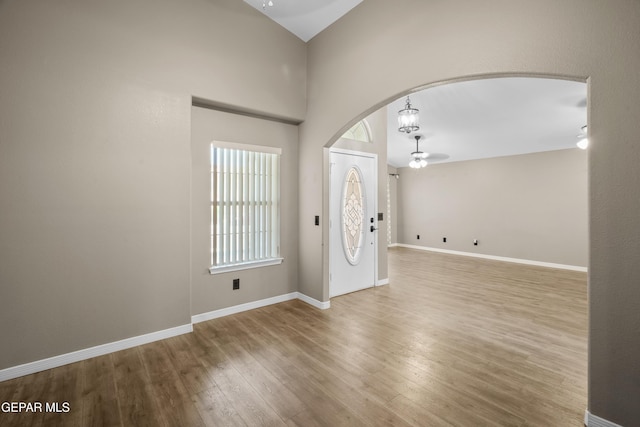 3928 Tierra Roman Dr, El Paso, TX 79938 - entrance foyer with arched walkways, wood finished floors, and a chandelier