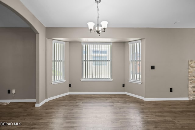 3928 Tierra Roman Dr, El Paso, TX 79938 - unfurnished dining area with plenty of natural light, wood finished floors, and arched walkways