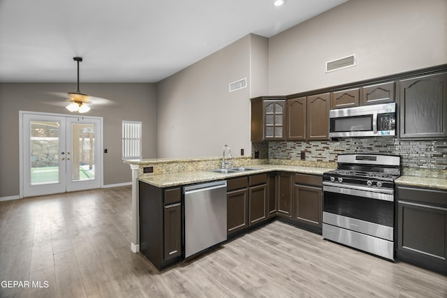 3928 Tierra Roman Dr, El Paso, TX 79938 - kitchen featuring stainless steel appliances, a peninsula, tasteful backsplash, light wood-type flooring, and recessed lighting