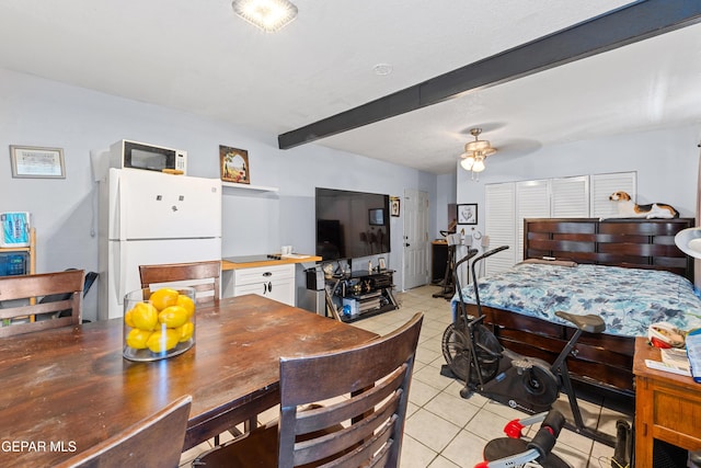 5656 Dailey Ave, El Paso, TX 79905 - bedroom featuring freestanding refrigerator, light tile patterned floors, and beamed ceiling