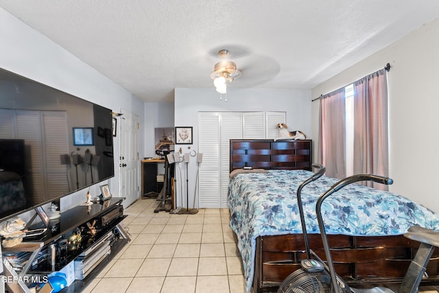 5656 Dailey Ave, El Paso, TX 79905 - bedroom featuring light tile patterned flooring, a textured ceiling, and a ceiling fan
