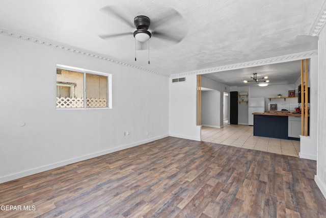 5656 Dailey Ave, El Paso, TX 79905 - unfurnished living room with wood finished floors, a ceiling fan, and a chandelier