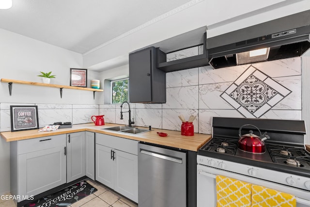 5656 Dailey Ave, El Paso, TX 79905 - kitchen featuring white range with gas stovetop, stainless steel dishwasher, open shelves, butcher block counters, and decorative backsplash