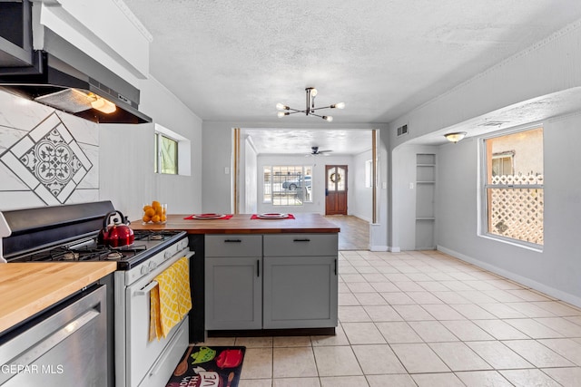 5656 Dailey Ave, El Paso, TX 79905 - kitchen with stainless steel appliances, wood counters, exhaust hood, gray cabinetry, and light tile patterned floors
