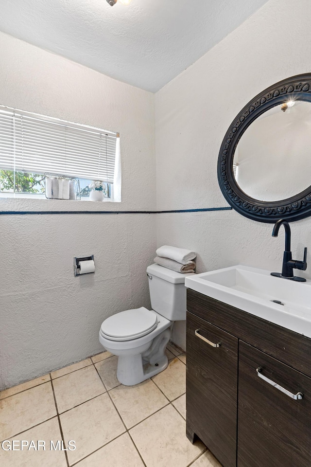 5656 Dailey Ave, El Paso, TX 79905 - bathroom featuring vanity, a textured wall, and tile patterned flooring