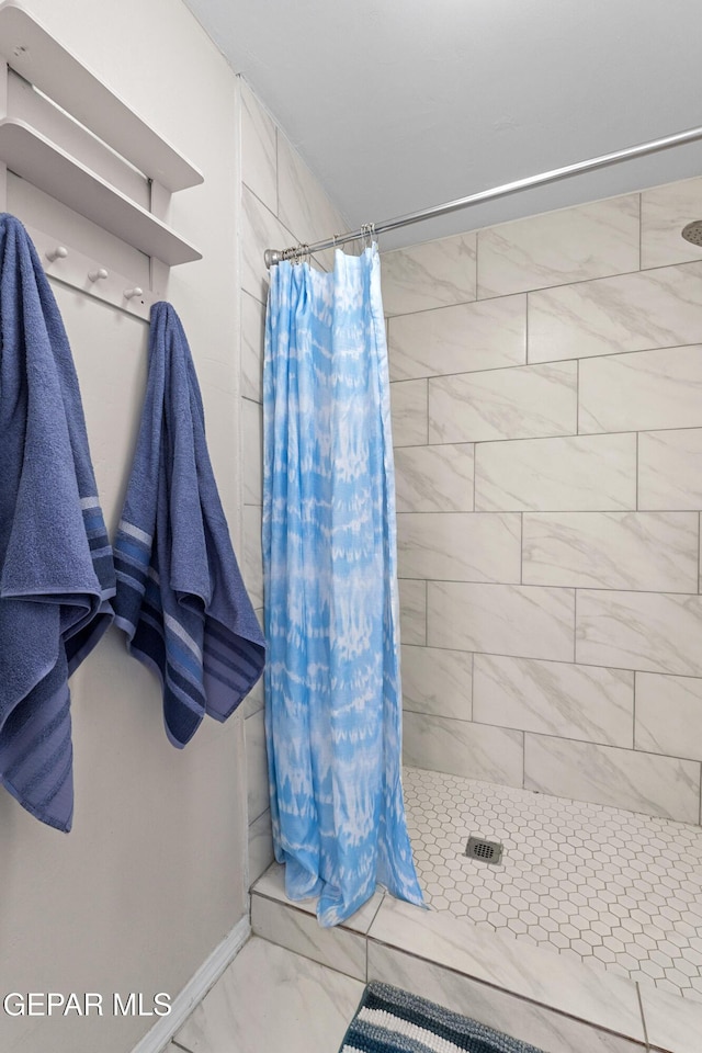 5656 Dailey Ave, El Paso, TX 79905 - bathroom with a shower stall and marble look tile flooring
