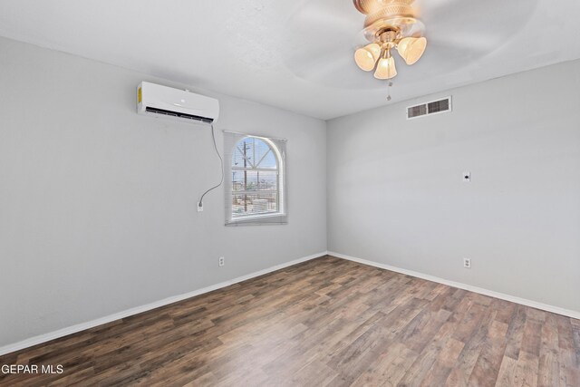 5656 Dailey Ave, El Paso, TX 79905 - spare room featuring a wall mounted air conditioner, wood finished floors, and ceiling fan