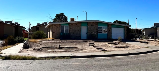 9212 Atun Way, El Paso, TX 79907 - view of front facade featuring concrete driveway, brick siding, and a garage