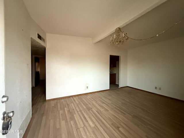 9212 Atun Way, El Paso, TX 79907 - unfurnished room with wood finished floors and a chandelier
