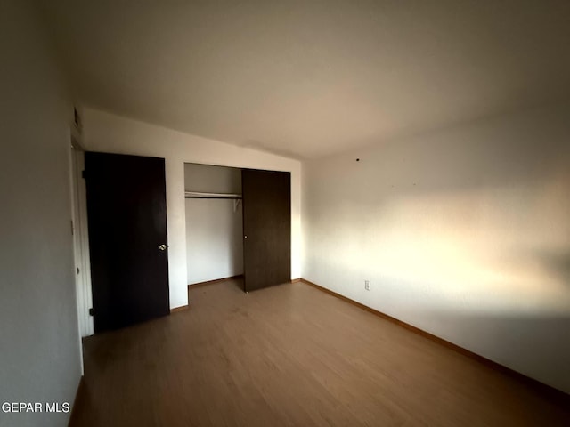 9212 Atun Way, El Paso, TX 79907 - unfurnished bedroom with dark wood-type flooring, a closet, and lofted ceiling