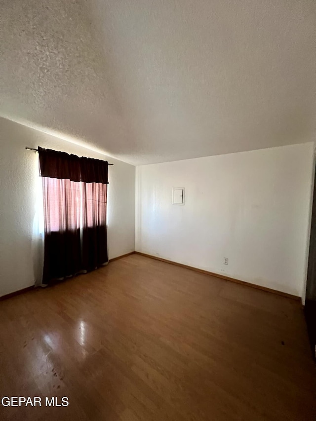 9212 Atun Way, El Paso, TX 79907 - unfurnished room with a textured ceiling and wood finished floors