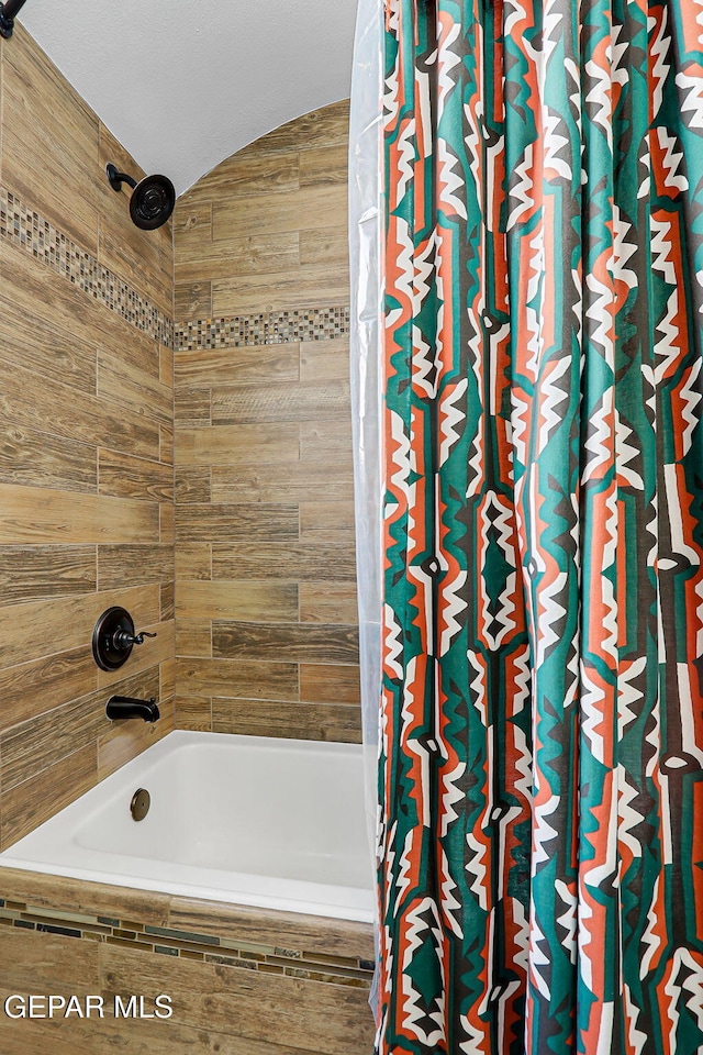 13474 Lawkland St, El Paso, TX 79928 - bathroom with shower / bath combo and lofted ceiling