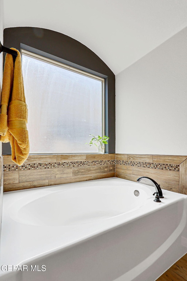 13474 Lawkland St, El Paso, TX 79928 - full bath featuring a garden tub and wood finished floors