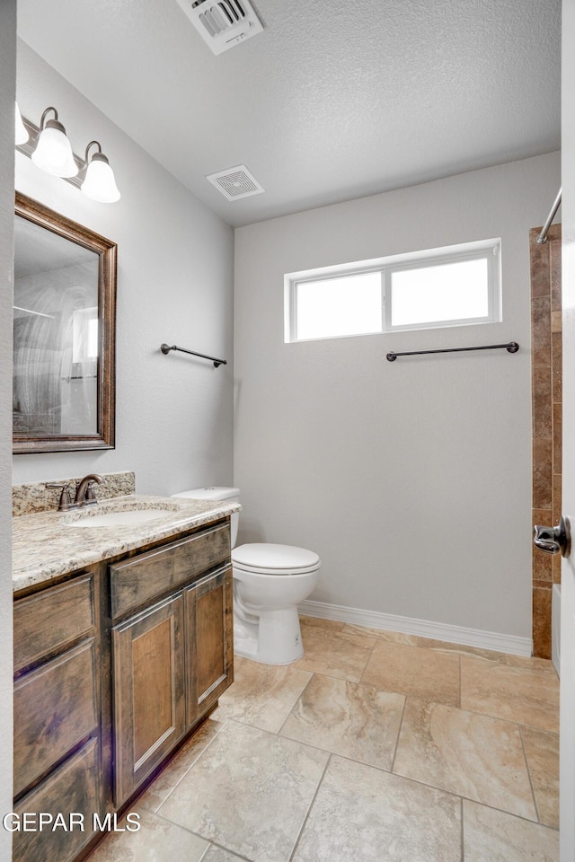 7548 Wolf Creek Dr, El Paso, TX 79911 - full bathroom featuring a tile shower and vanity