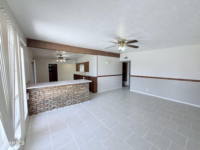 5542 Vancouver St, El Paso, TX 79924 - unfurnished living room featuring a ceiling fan, a textured ceiling, and light tile patterned flooring
