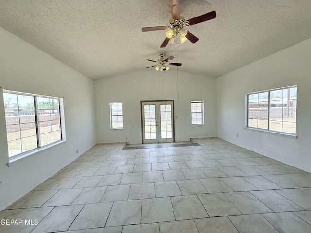 5542 Vancouver St, El Paso, TX 79924 - unfurnished room with plenty of natural light, lofted ceiling, ceiling fan, a textured ceiling, and french doors