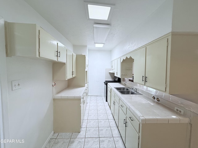 5542 Vancouver St, El Paso, TX 79924 - kitchen featuring gas stove and tile countertops