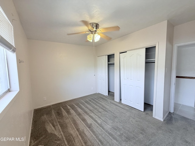 5542 Vancouver St, El Paso, TX 79924 - unfurnished bedroom featuring carpet flooring, two closets, and ceiling fan