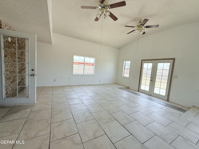 5542 Vancouver St, El Paso, TX 79924 - unfurnished room with french doors, a textured ceiling, vaulted ceiling, ceiling fan, and light tile patterned floors