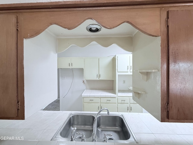 5542 Vancouver St, El Paso, TX 79924 - kitchen featuring tile counters and white cabinets