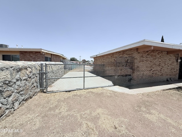 5542 Vancouver St, El Paso, TX 79924 - view of property exterior featuring brick siding and a gate