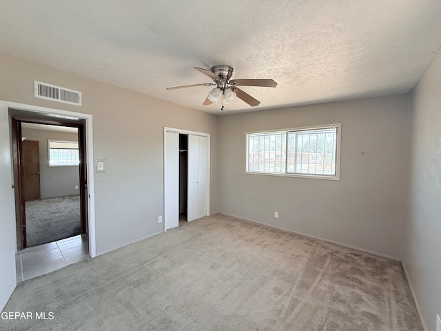 5542 Vancouver St, El Paso, TX 79924 - unfurnished bedroom with light carpet, a closet, and a ceiling fan