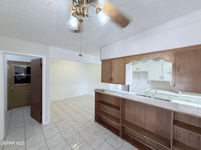 5542 Vancouver St, El Paso, TX 79924 - kitchen with light countertops, a textured ceiling, and open shelves