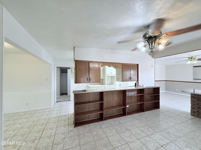 5542 Vancouver St, El Paso, TX 79924 - kitchen featuring open shelves, ceiling fan, light countertops, and a textured ceiling