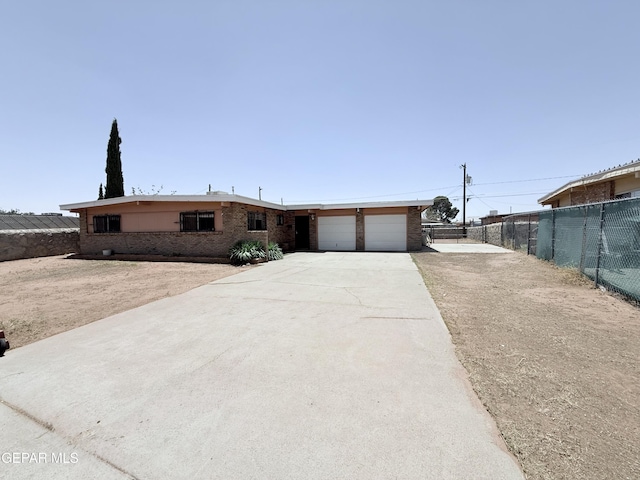 5542 Vancouver St, El Paso, TX 79924 - view of front of home with a garage, driveway, and brick siding