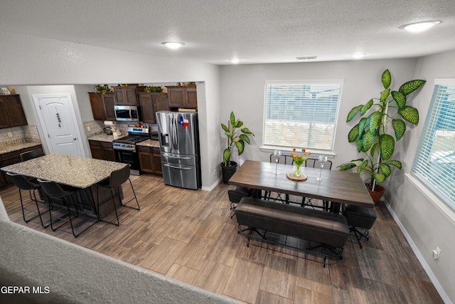 10625 Hidden Links Pl, El Paso, TX 79924 - dining room featuring light wood-style floors and a textured ceiling